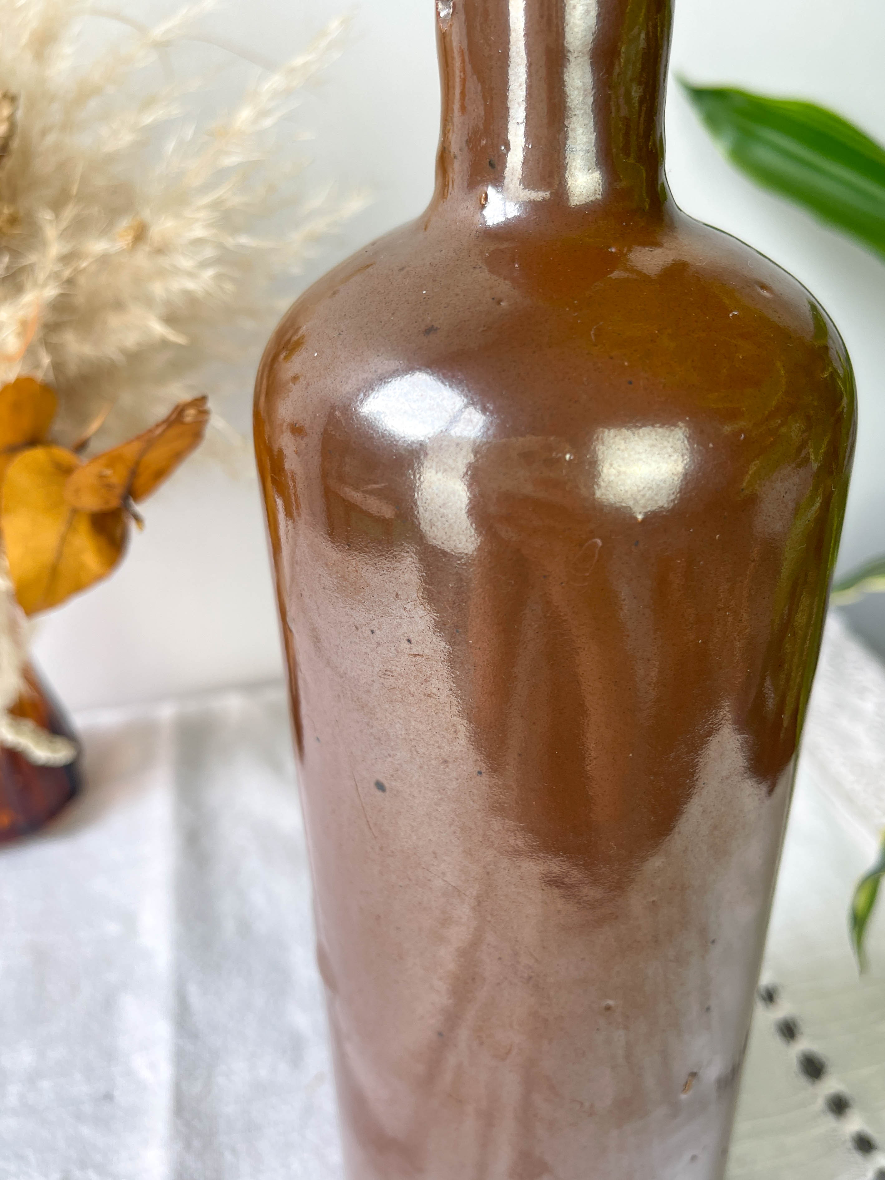 Vintage iridescent brown stoneware bottle