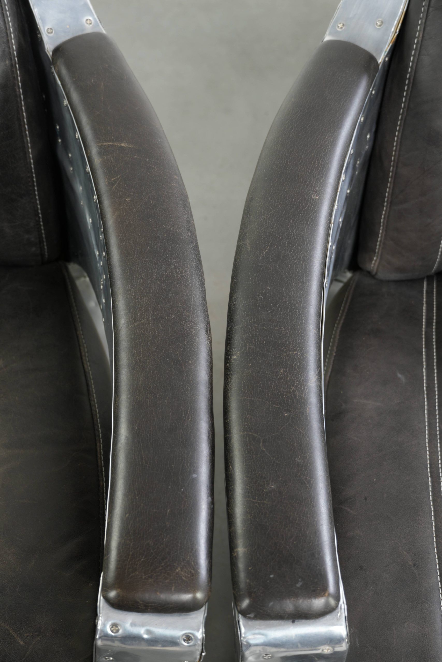 Set of 2 sturdy industrial black cowhide Aviator design armchairs with aluminium and rivets