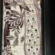 Three manganese Delft tiles forming a portrait of a peacock, 18th century.