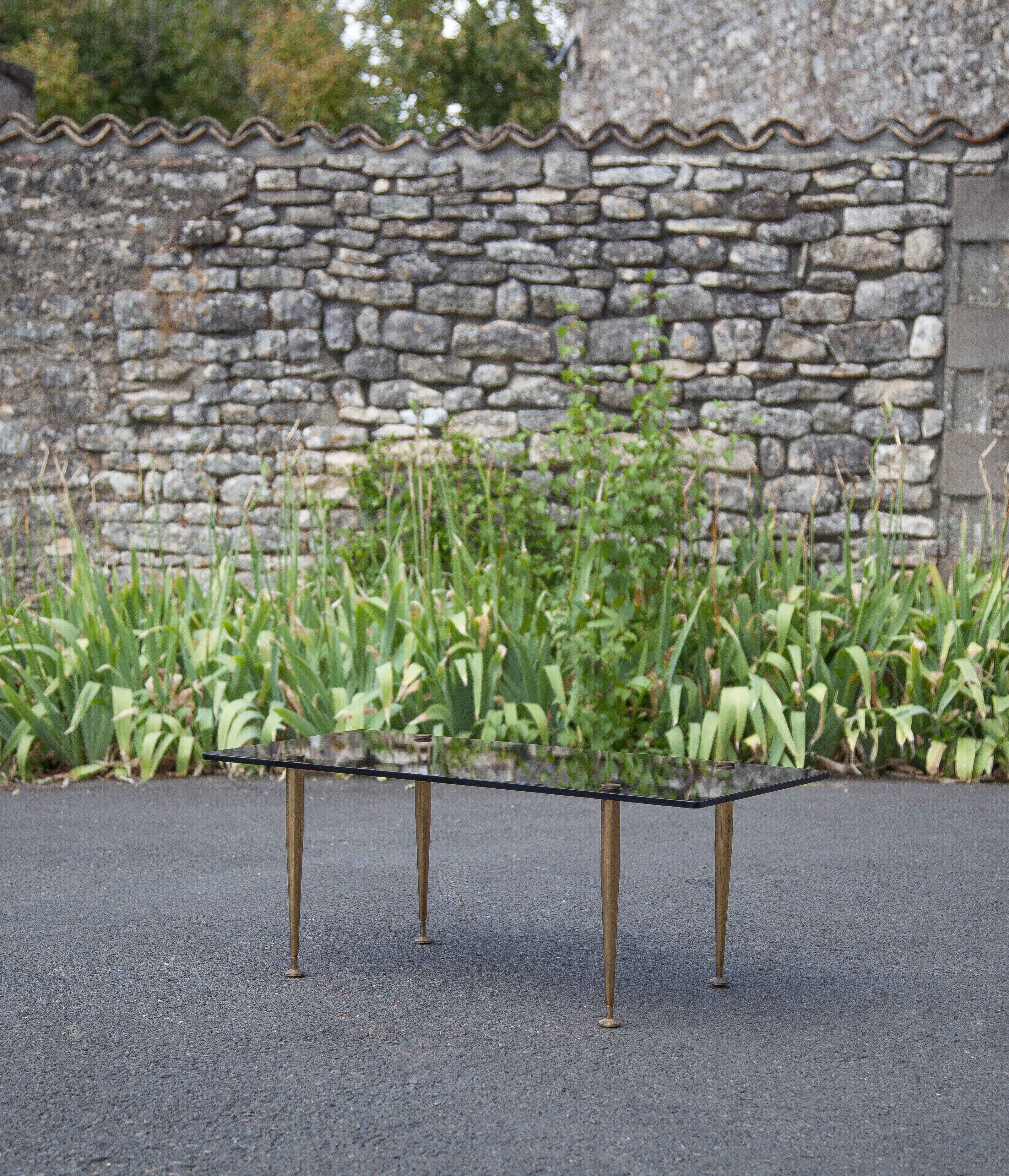 Smoked glass coffee table with adjustable brass legs, end of sofa, 70s table