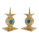 Pair of brass candlesticks decorated with a blue stone inlaid in the center