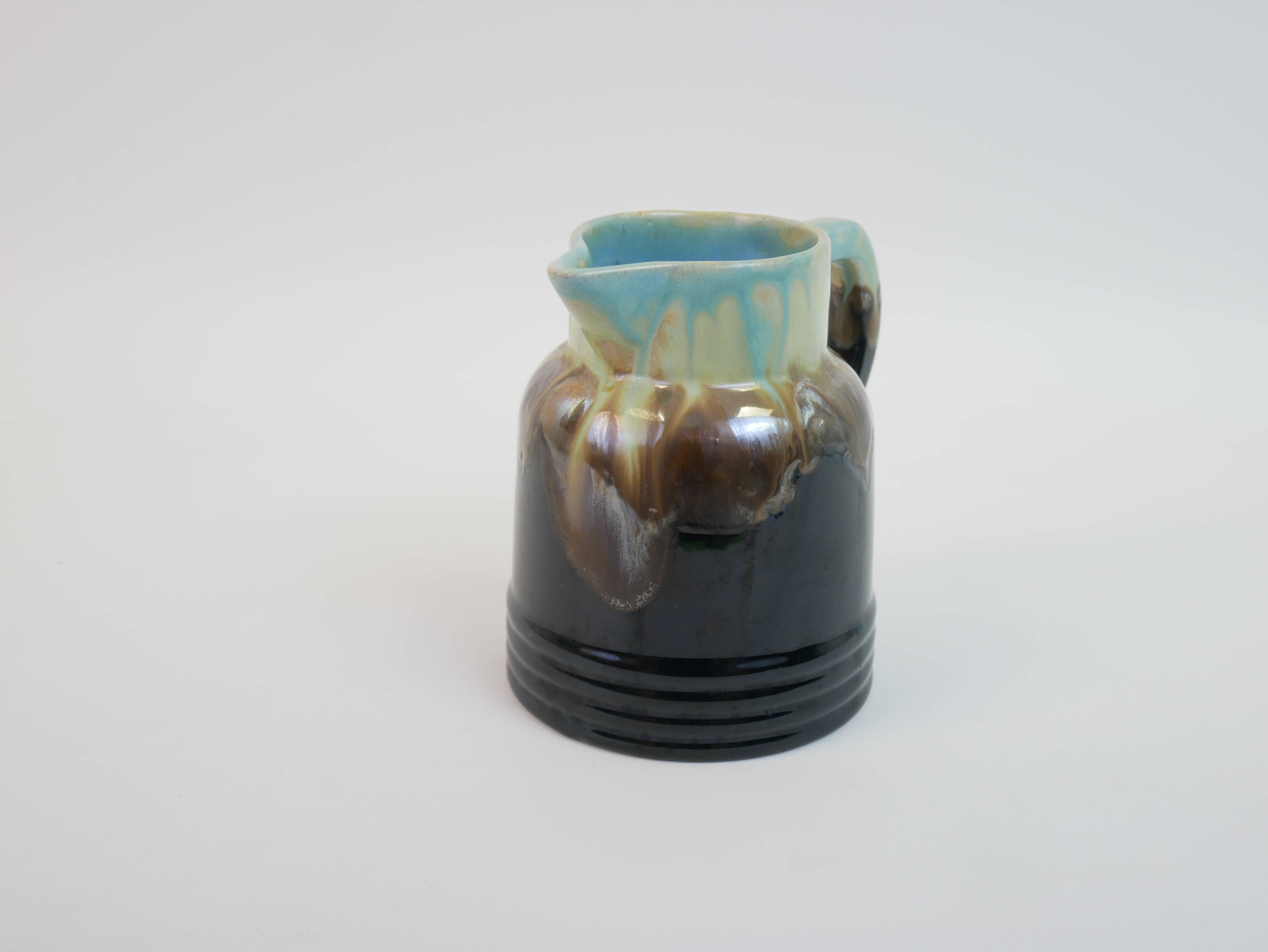 Art Deco pitcher in black, brown and blue glazed ceramic