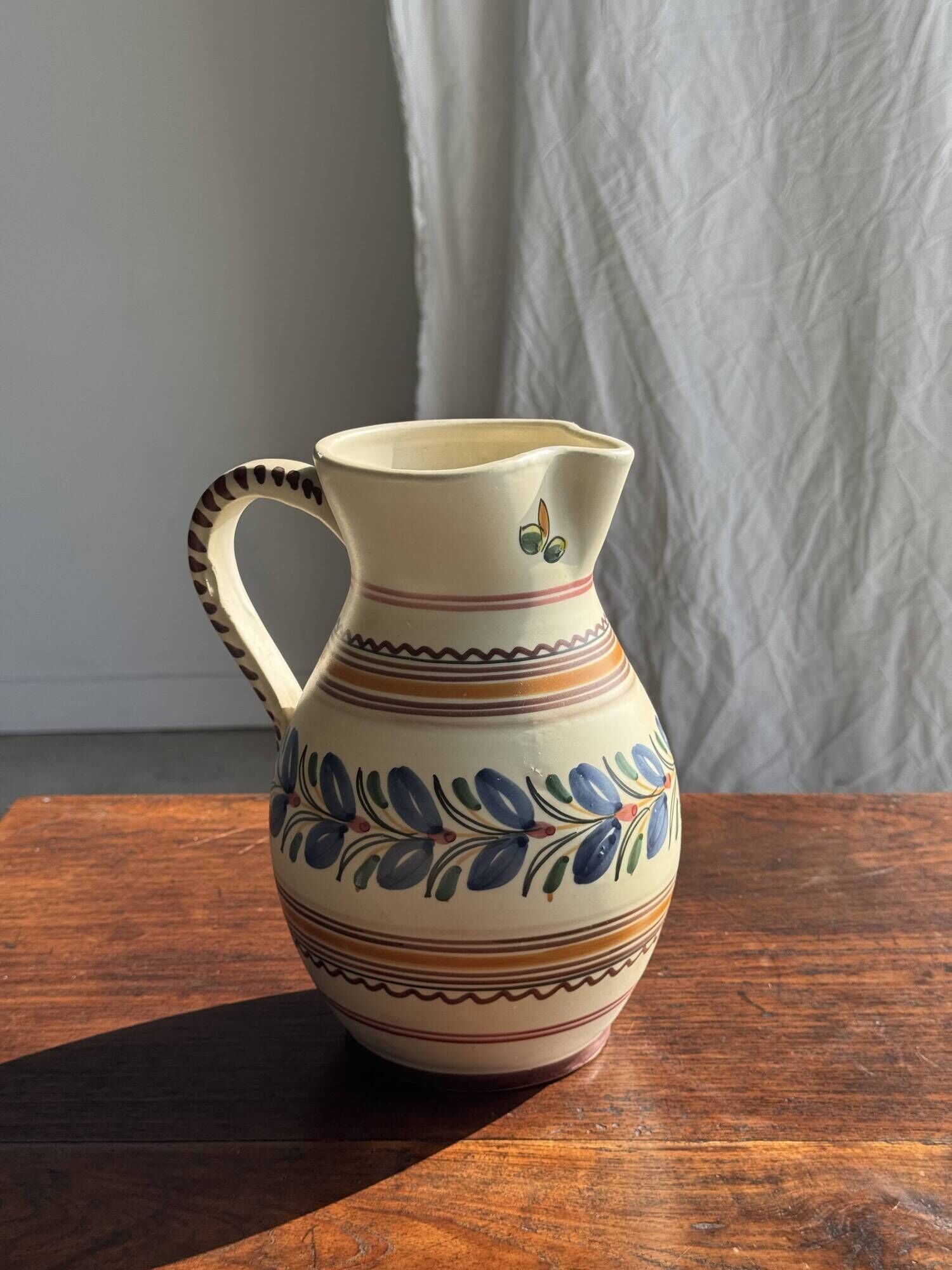 Beige carafe with stylized blue flower friezes