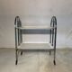 Vintage folding dessert table in chrome metal with enamelled trays.