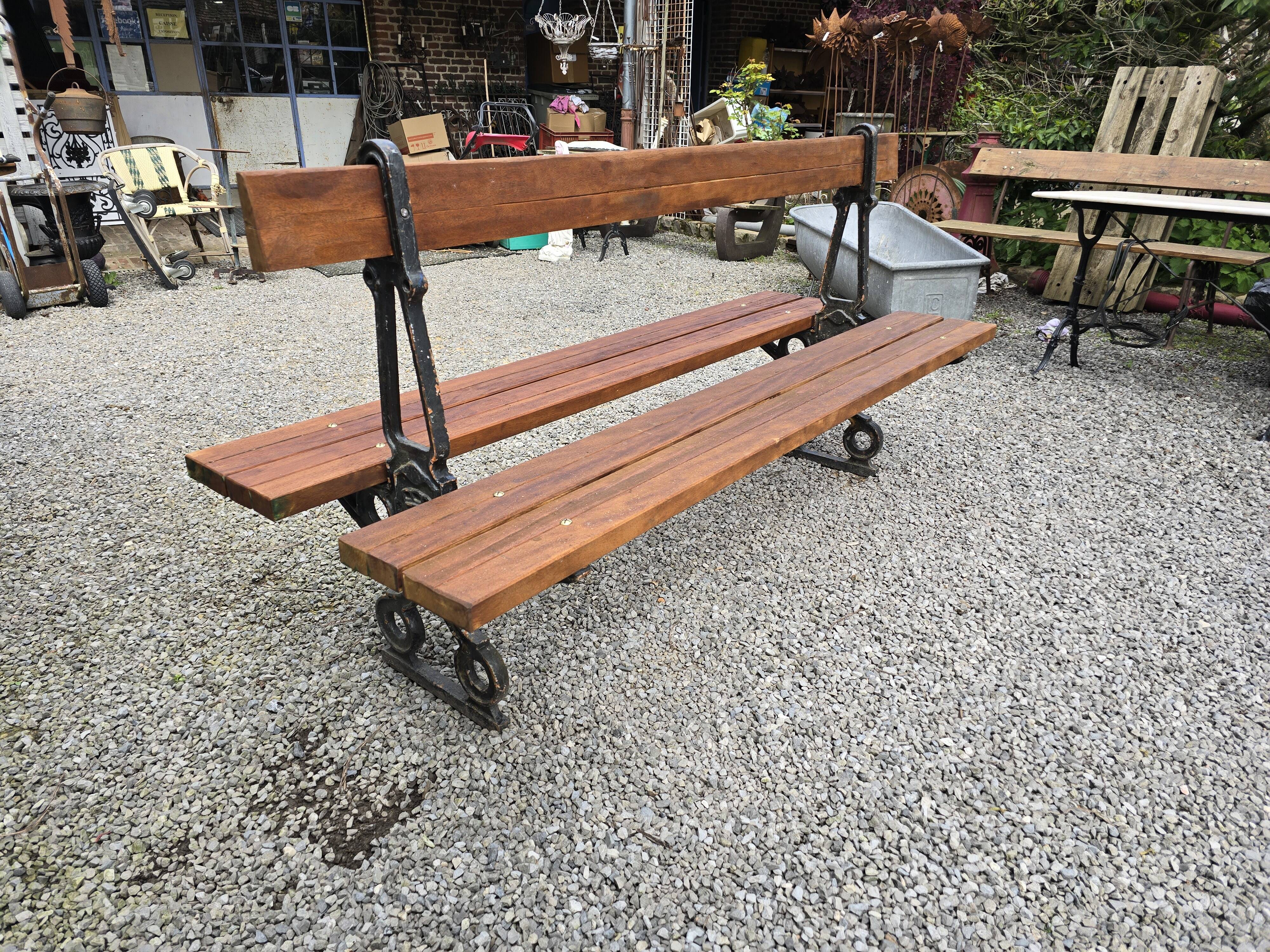 Antique double garden bench from the city of Paris in cast iron and wood