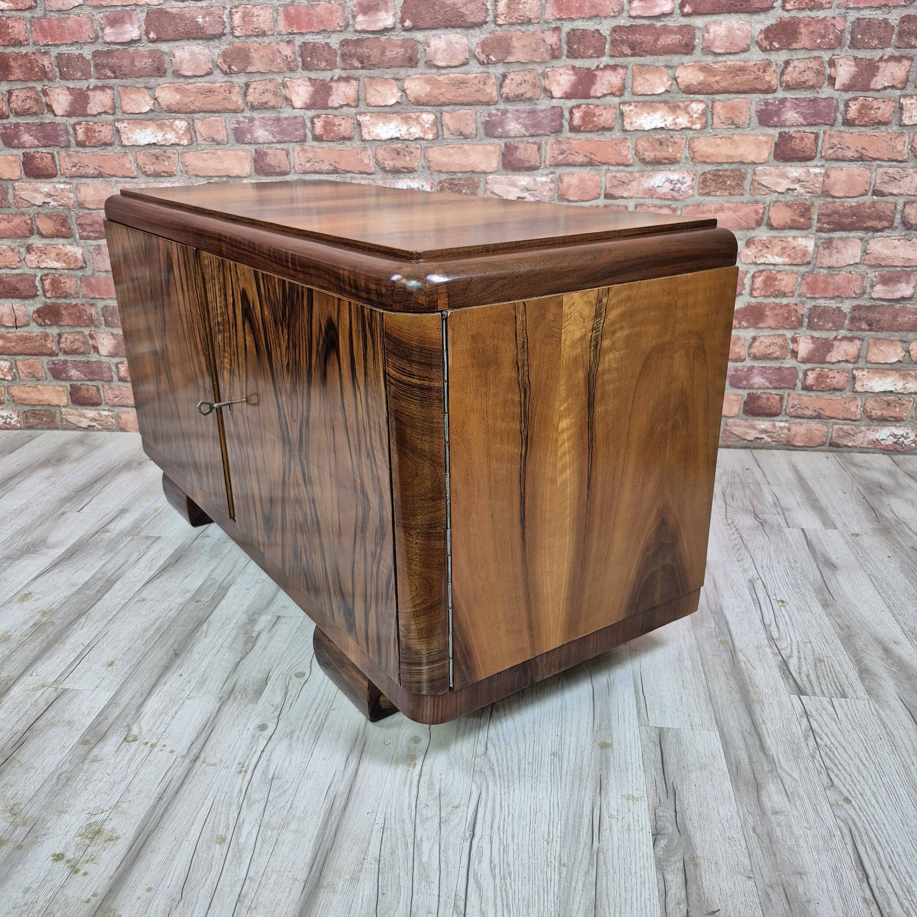 Low sideboard after renovation. Hypnotising veneer and Art Deco style.