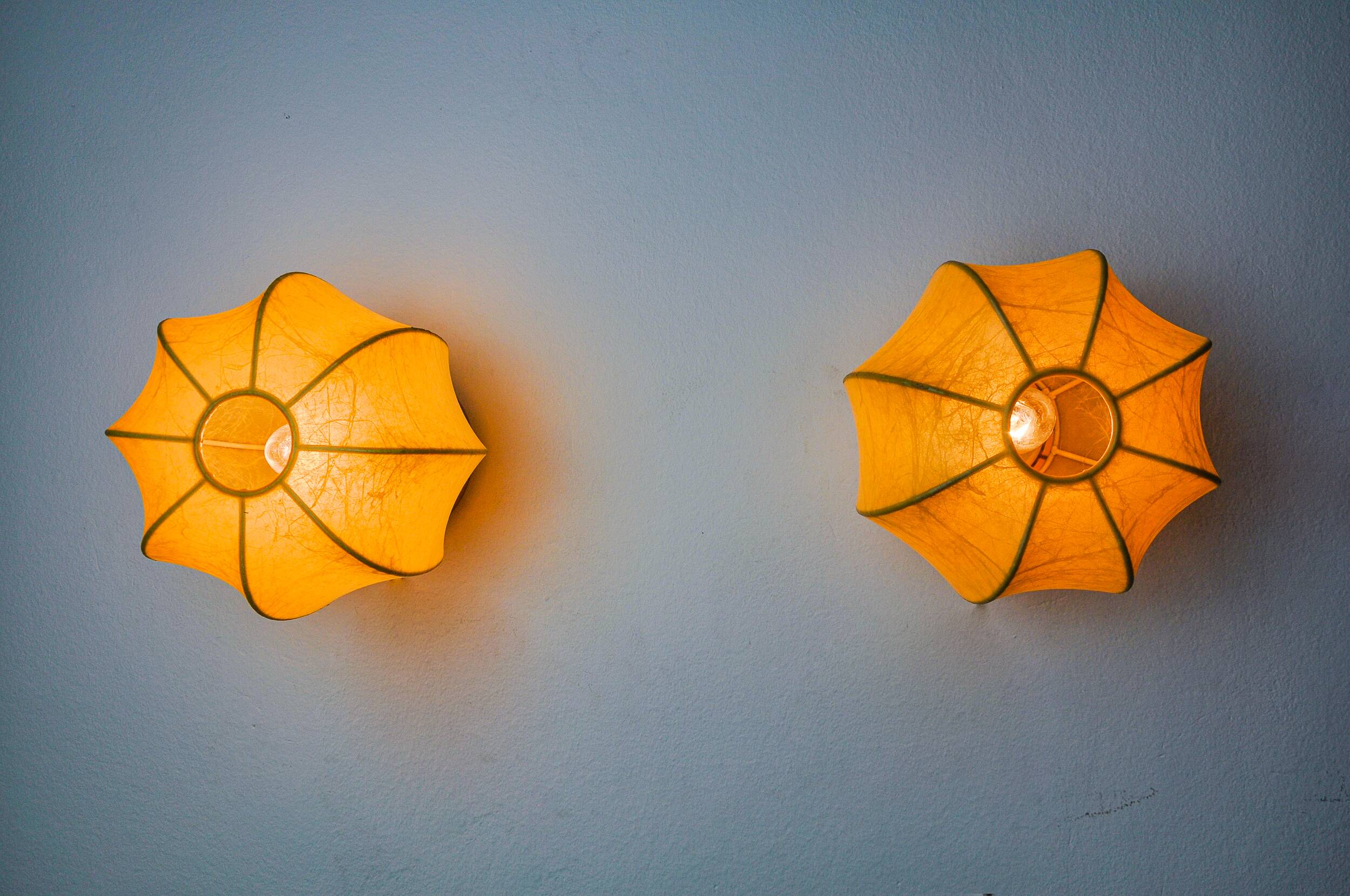 Pair of circular "cocoon" wall lights, resin and pine, Italy, 1970