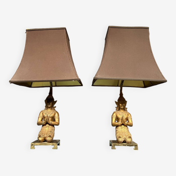 Pair of table lamps with bronze Buddha figurines.