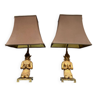 Pair of table lamps with bronze Buddha figurines.