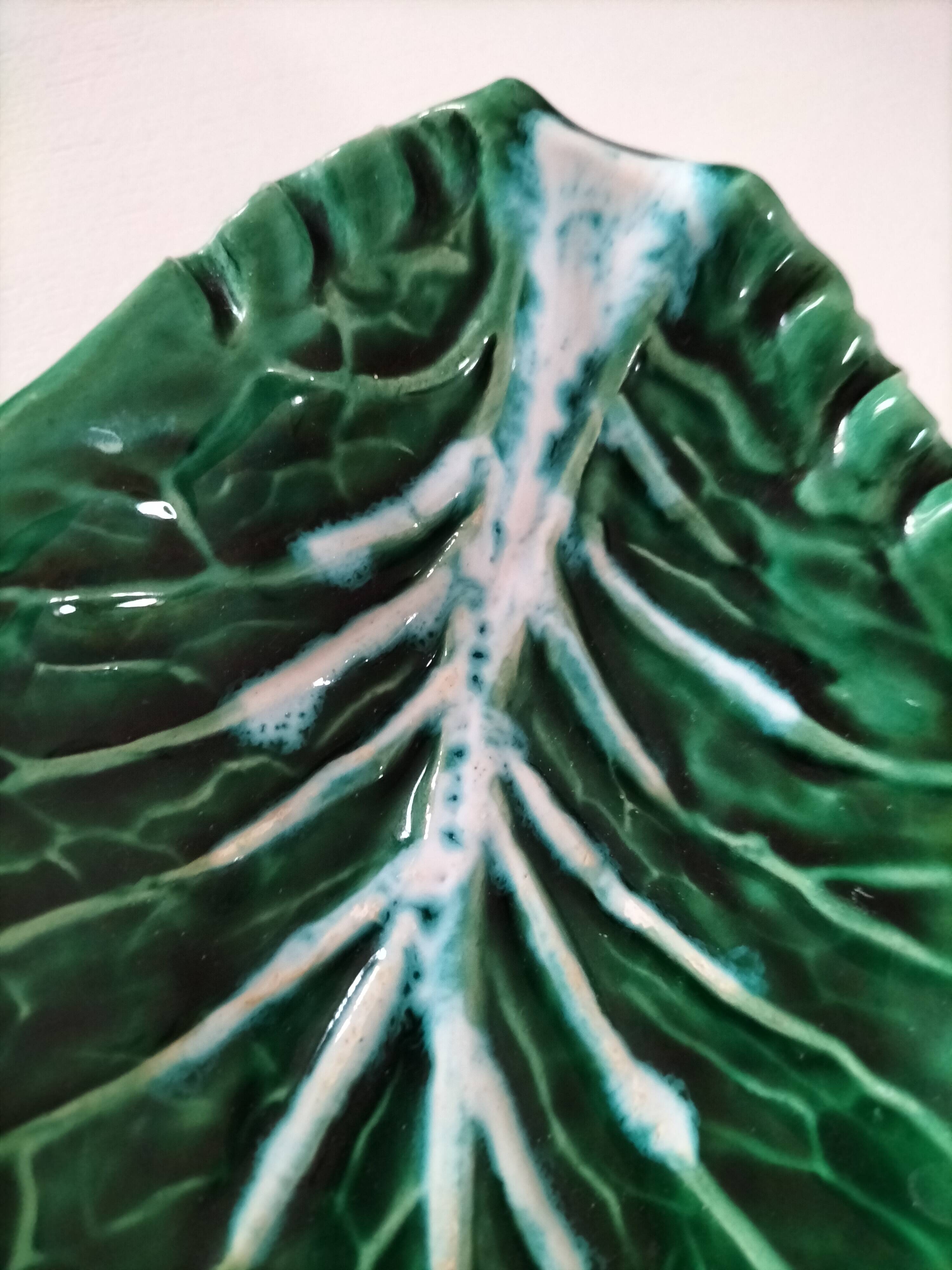 Vintage green slipware bowl in the shape of a cabbage leaf.