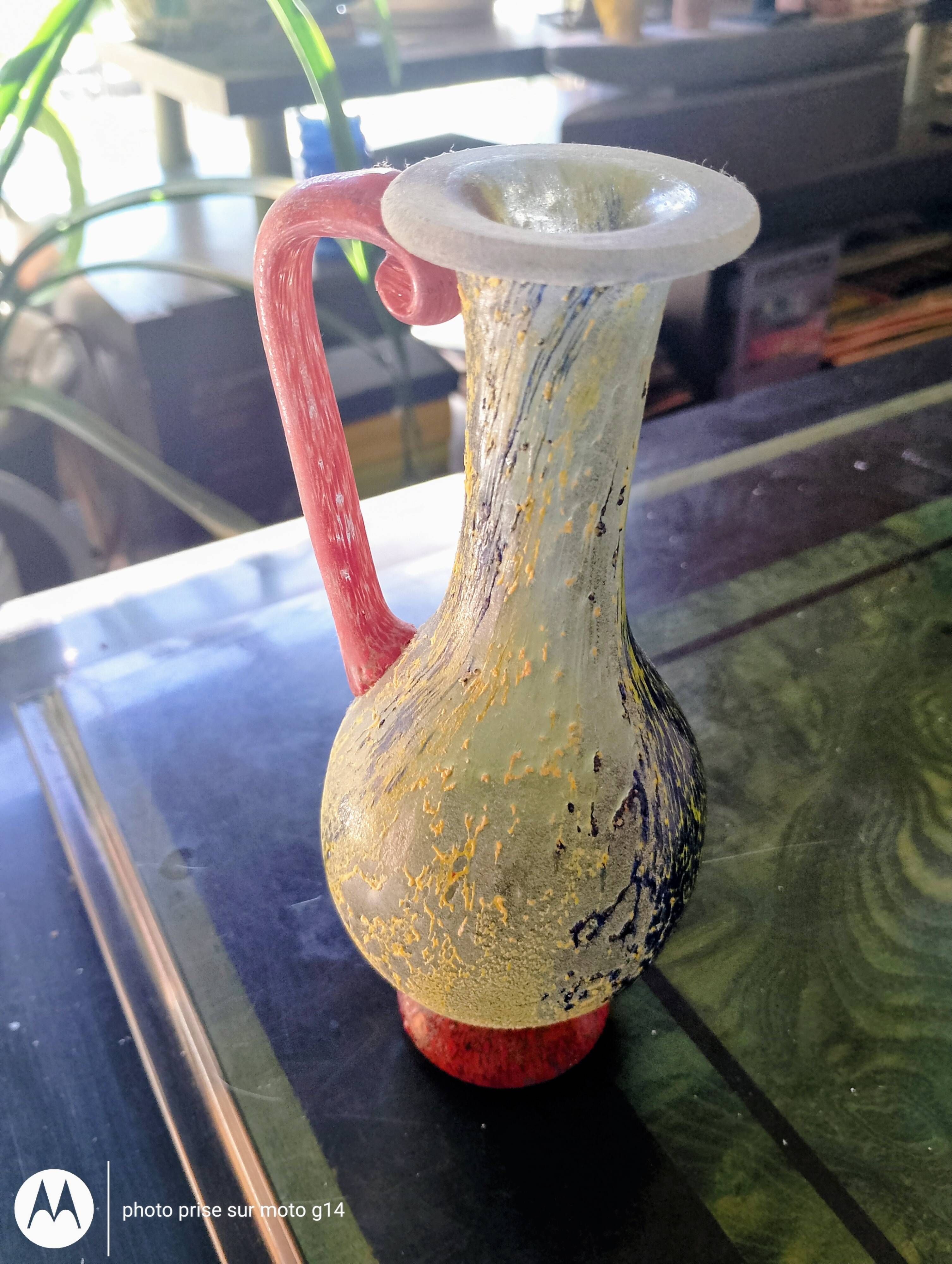 Small vintage glass vase with a red handle – Speckled green and yellow decoration