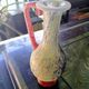 Small vintage glass vase with a red handle – Speckled green and yellow decoration