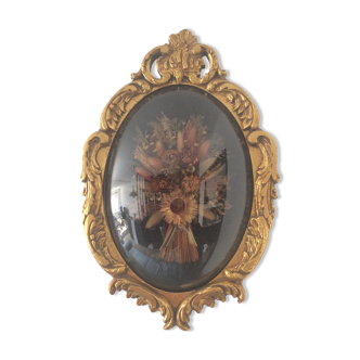 Golden wood frame and vintage bulging glass