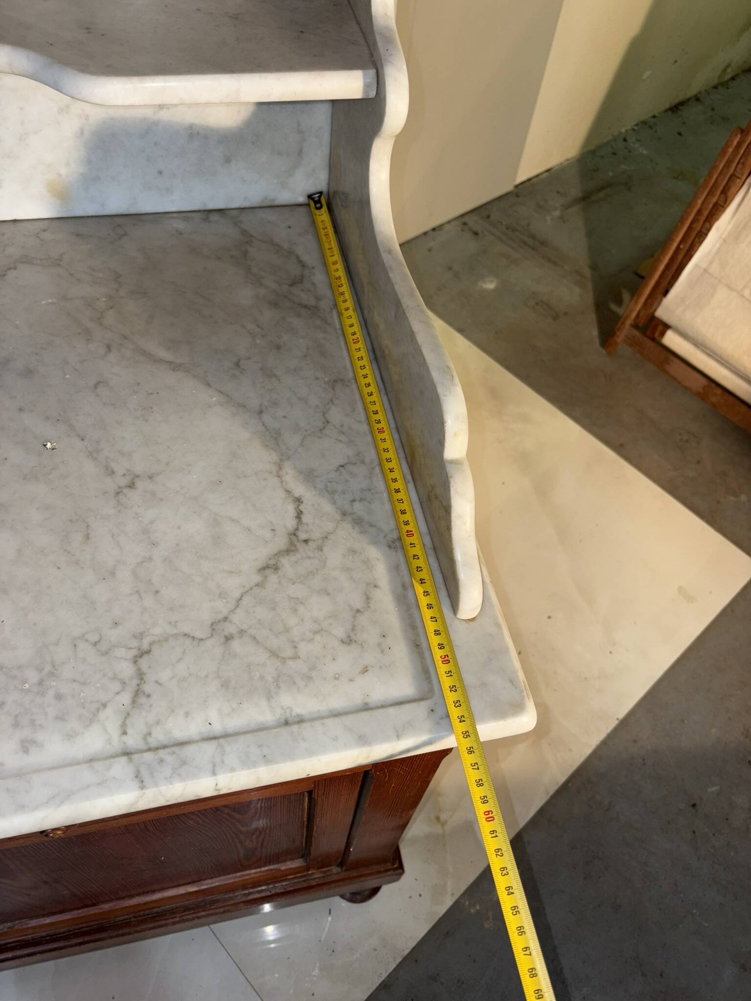 Antique wood and marble kitchen sideboard with carved backsplash