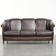 Unique sheepskin 3-seater sofa with deep colours and a distinctive design