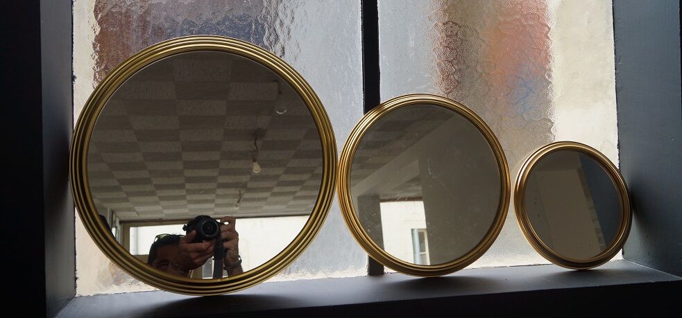 Suite of three brass mirrors