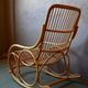 Vintage rocking chair in rattan from the 60s-70s, high openwork backrest.