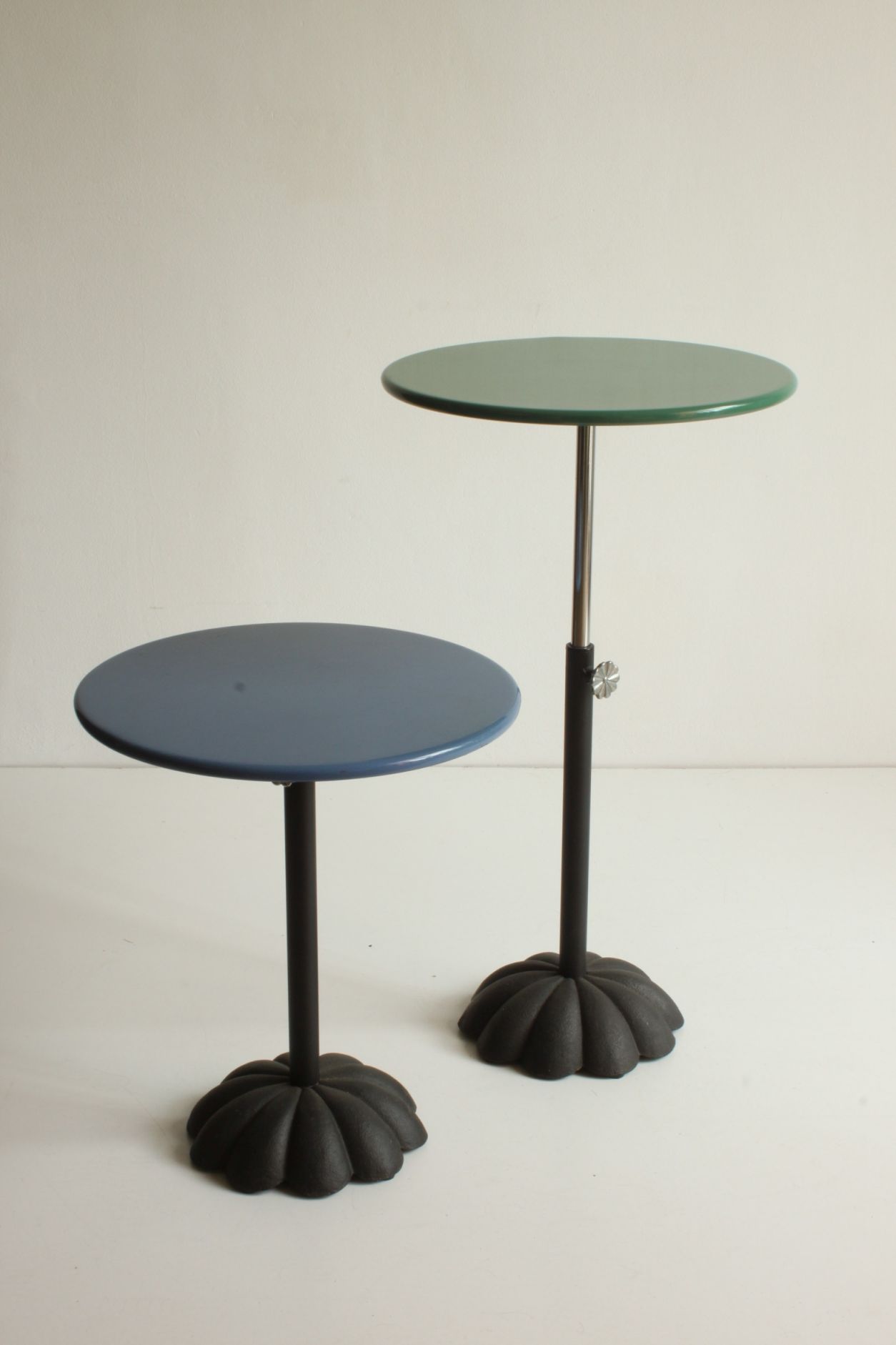 Postmodern cast iron flower base adjustable round side tables, blue and green, 1980s.