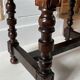 Antique turned wooden stool with woven leather.