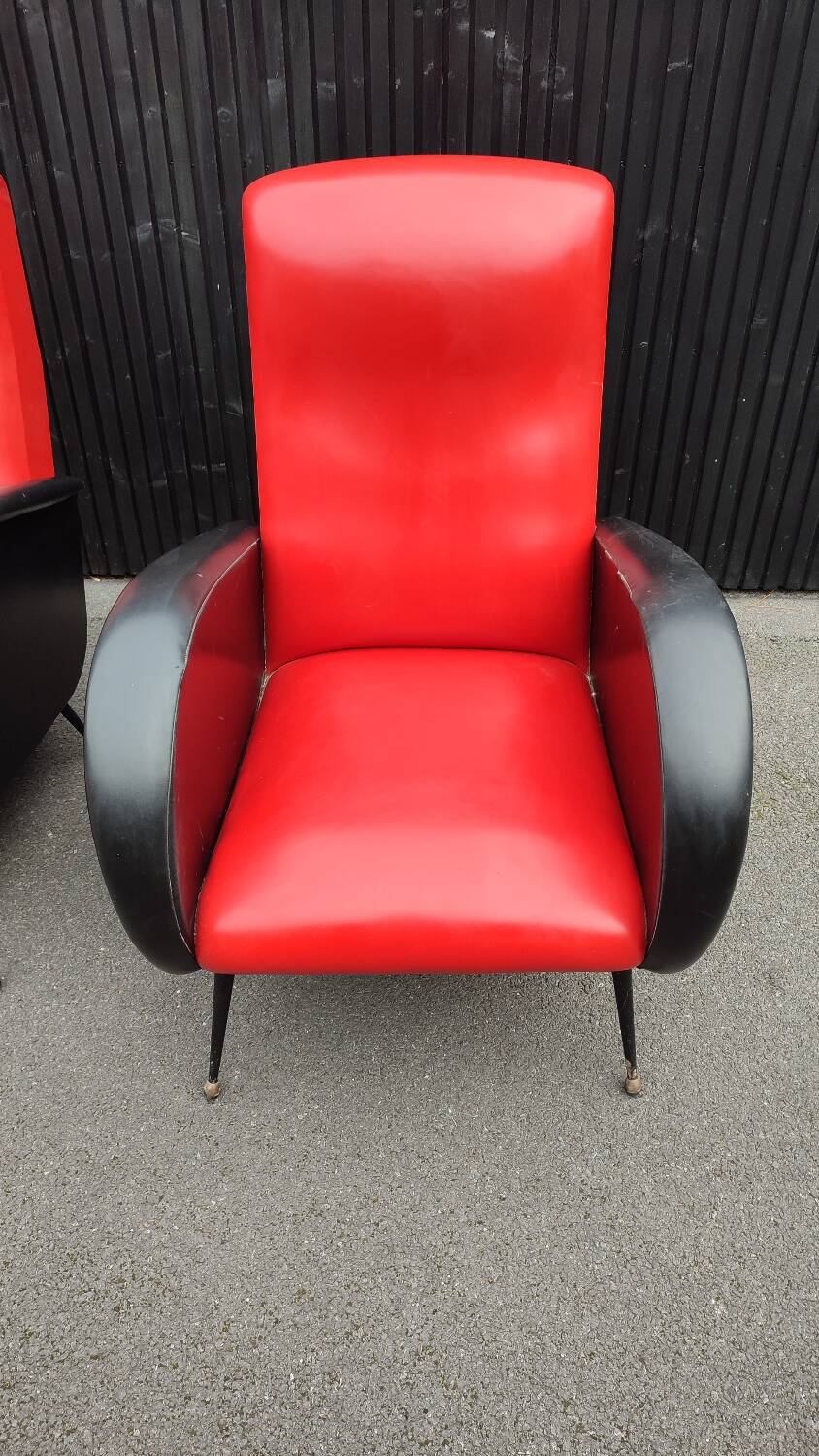 Pair of red and black faux leather armchairs