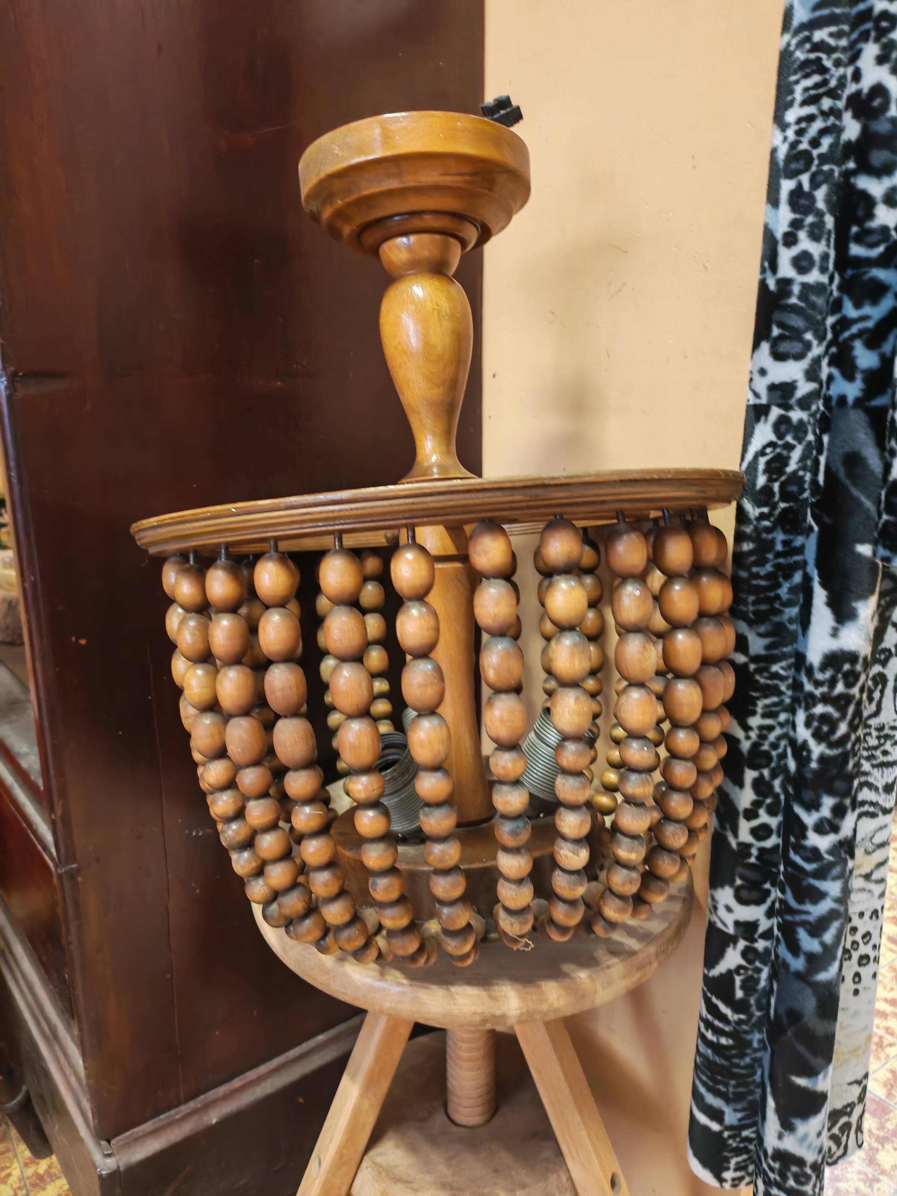 Vintage wooden turned cage chandelier with beads from the 1960s.