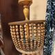 Vintage wooden turned cage chandelier with beads from the 1960s.