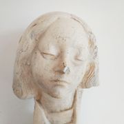 Bust of woman in plaster on pedestal with inscription