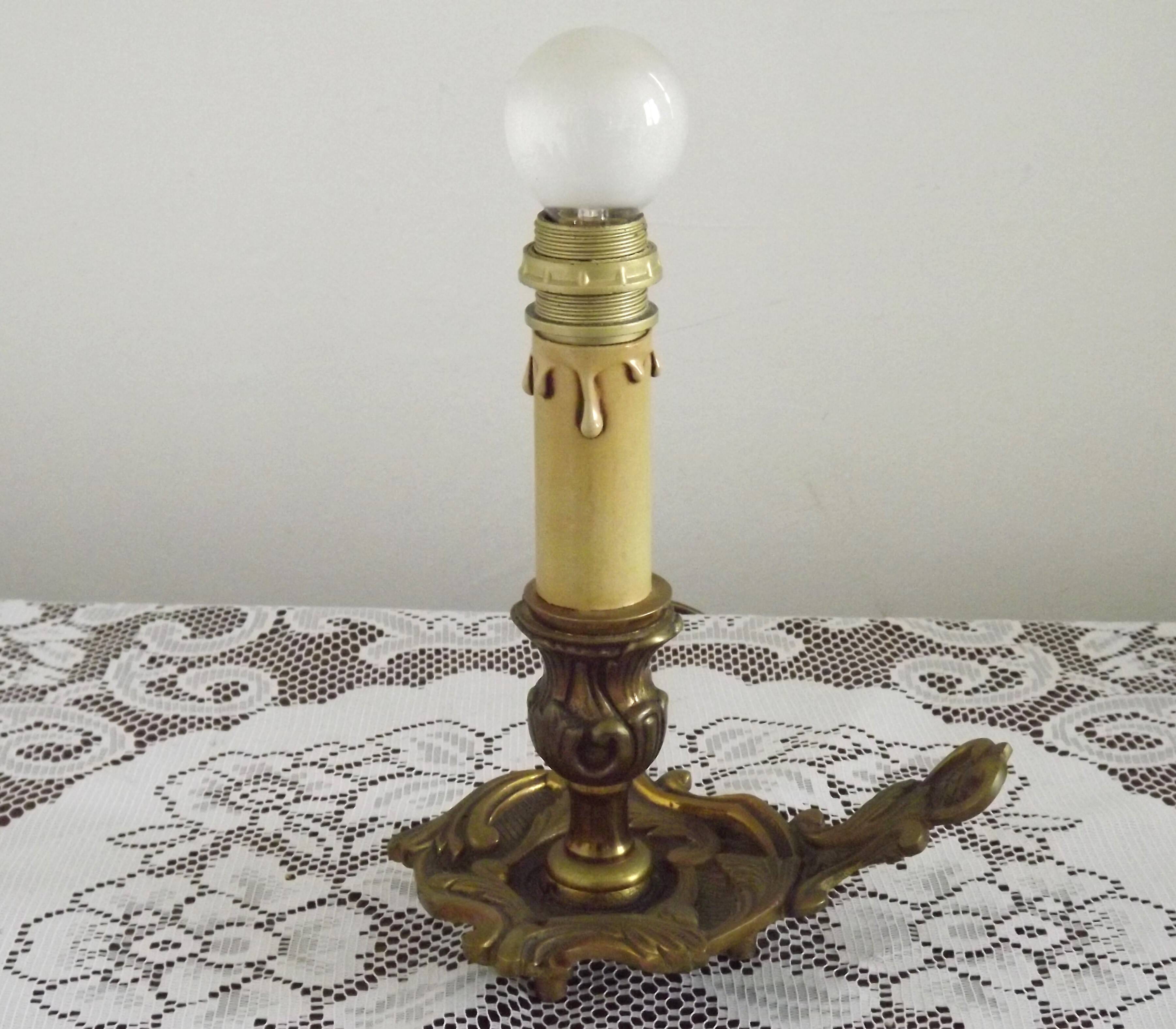 Vintage French bronze Wee Willie Winkie style lamp with red card shade.