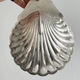 Old metal plate in the shape of a shell.