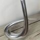 Sculptural vase design in polished aluminium.