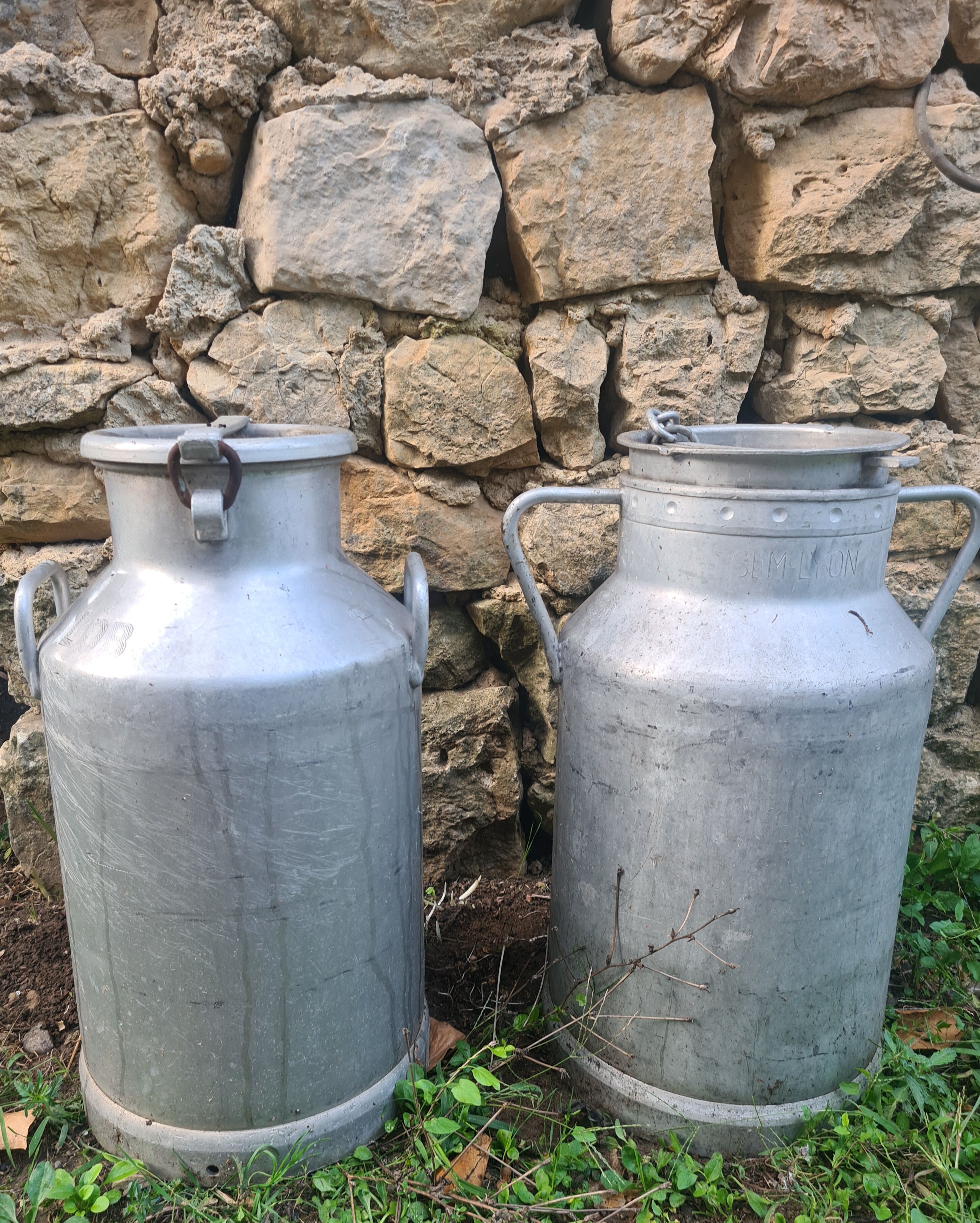 set of 2 old aluminum milk jugs