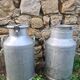 set of 2 old aluminum milk jugs