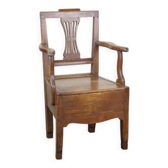 Antique 18th-century English oak armchair with armrests and an ornament