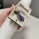 Old bathroom lamp with brown/golden ceramic base, porcelain socket and milky white glass
