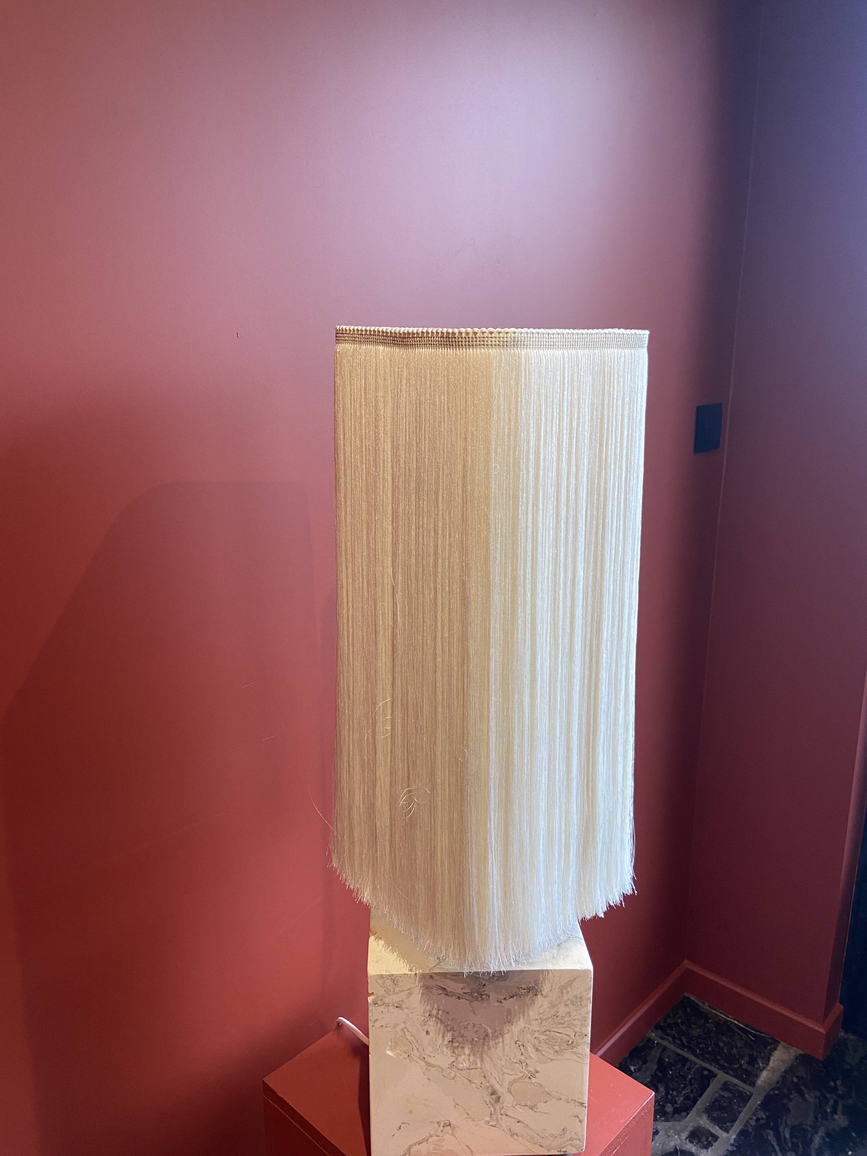 Beige marble stucco base, Houles white ecru fringed lampshade.