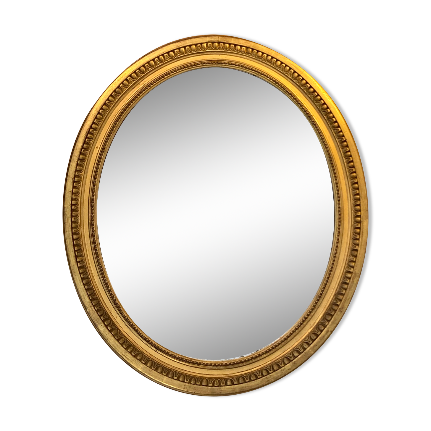 Oval mirror in carved wood, stuccoed and gilded with leaf Louis XVI style late nineteenth century