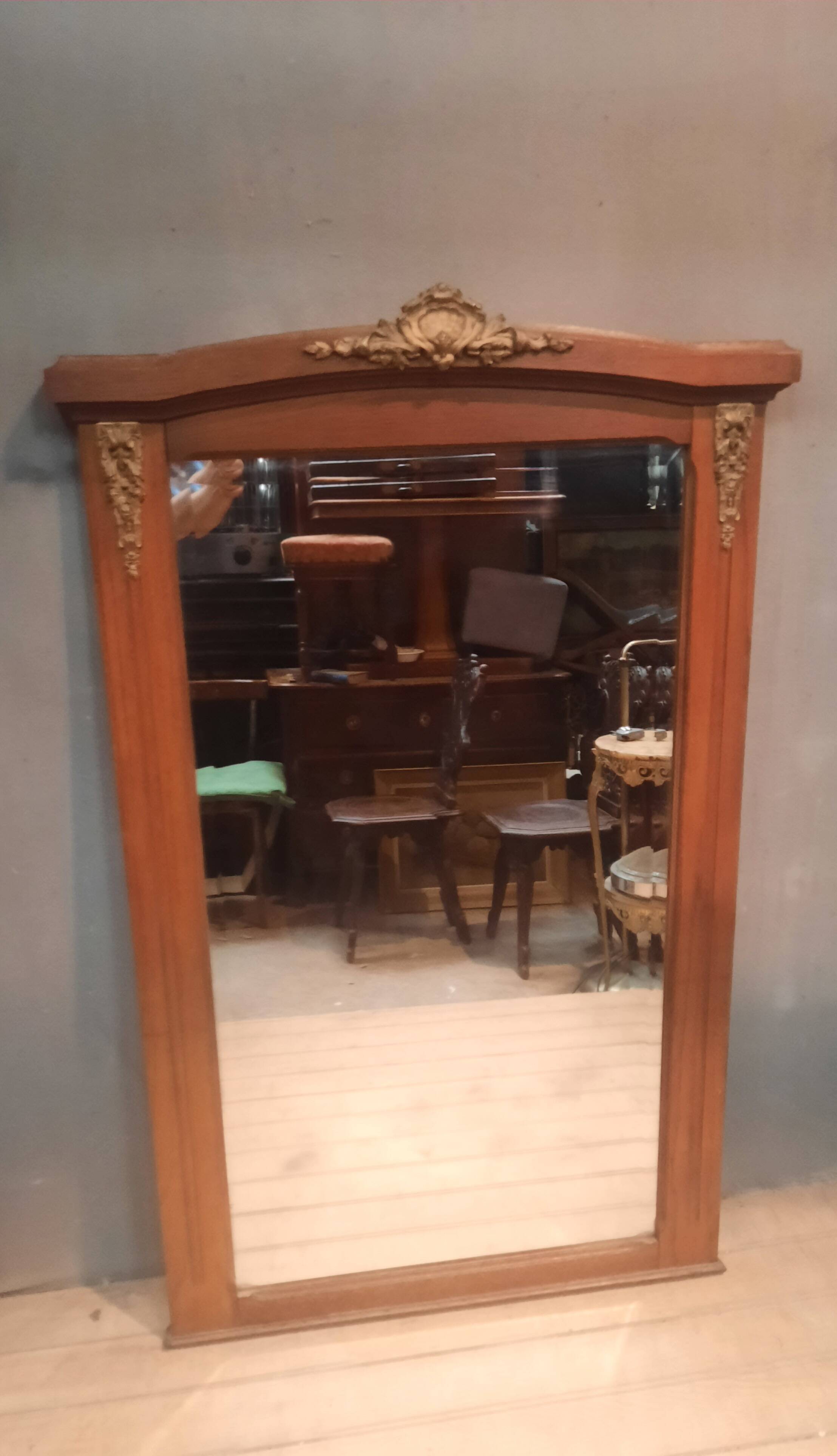 Bevelled mirror surrounded by a wooden frame.