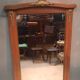Bevelled mirror surrounded by a wooden frame.