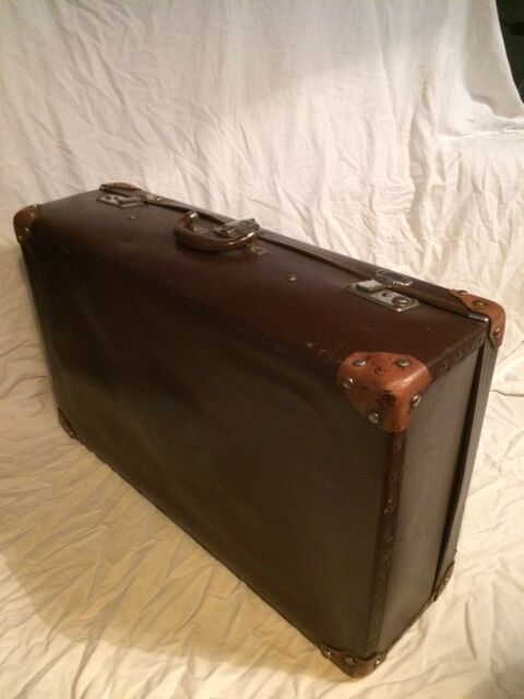 Suitcase vintage leather inside and brown carpeted home