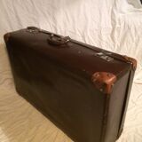 Suitcase vintage leather inside and brown carpeted home