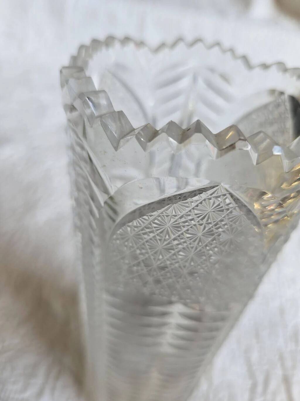 Antique cut crystal vase with a scalloped edge, decorated with palmettes.