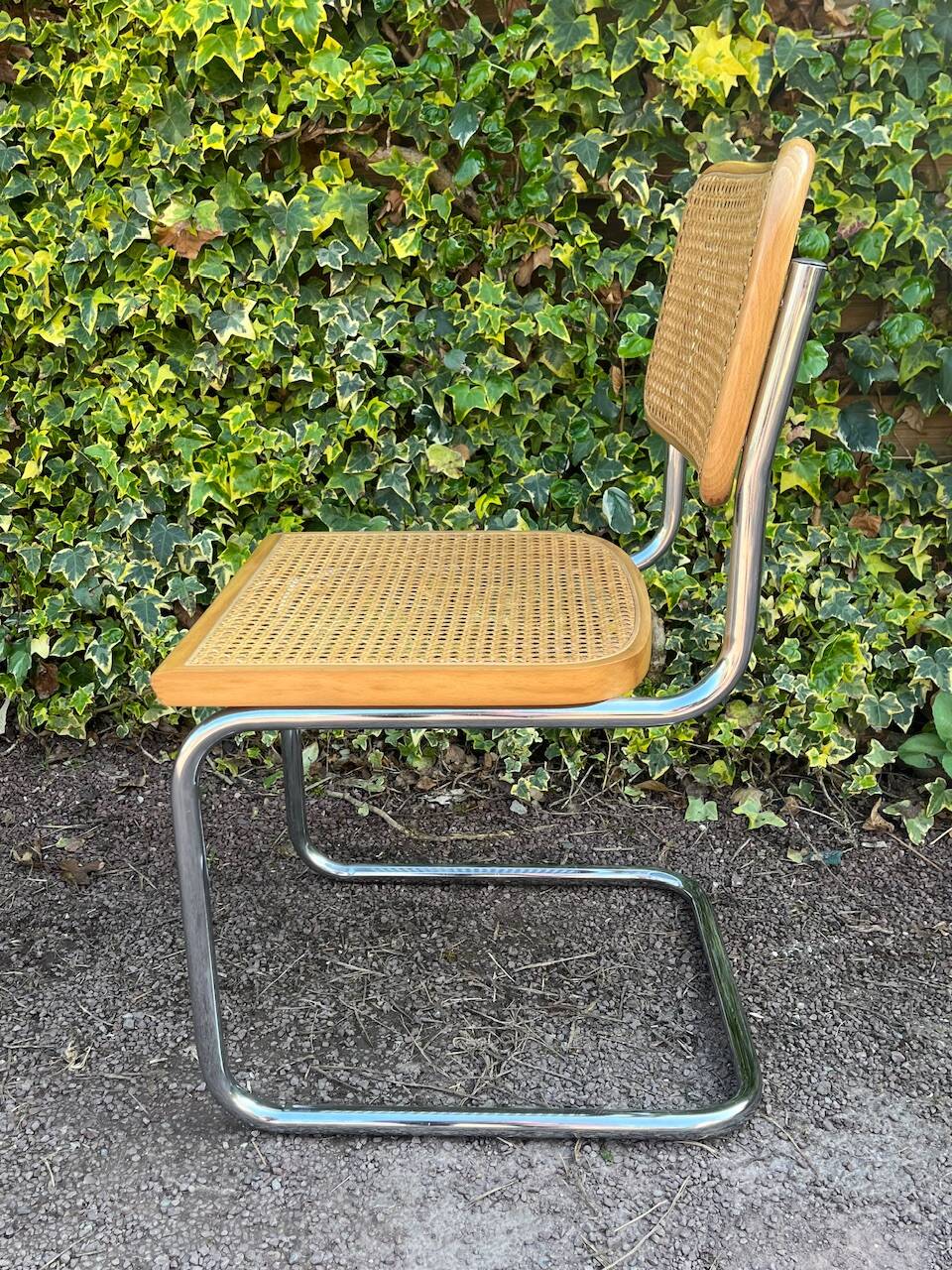 Wooden chair with caning in the style of Marcel Breuer.