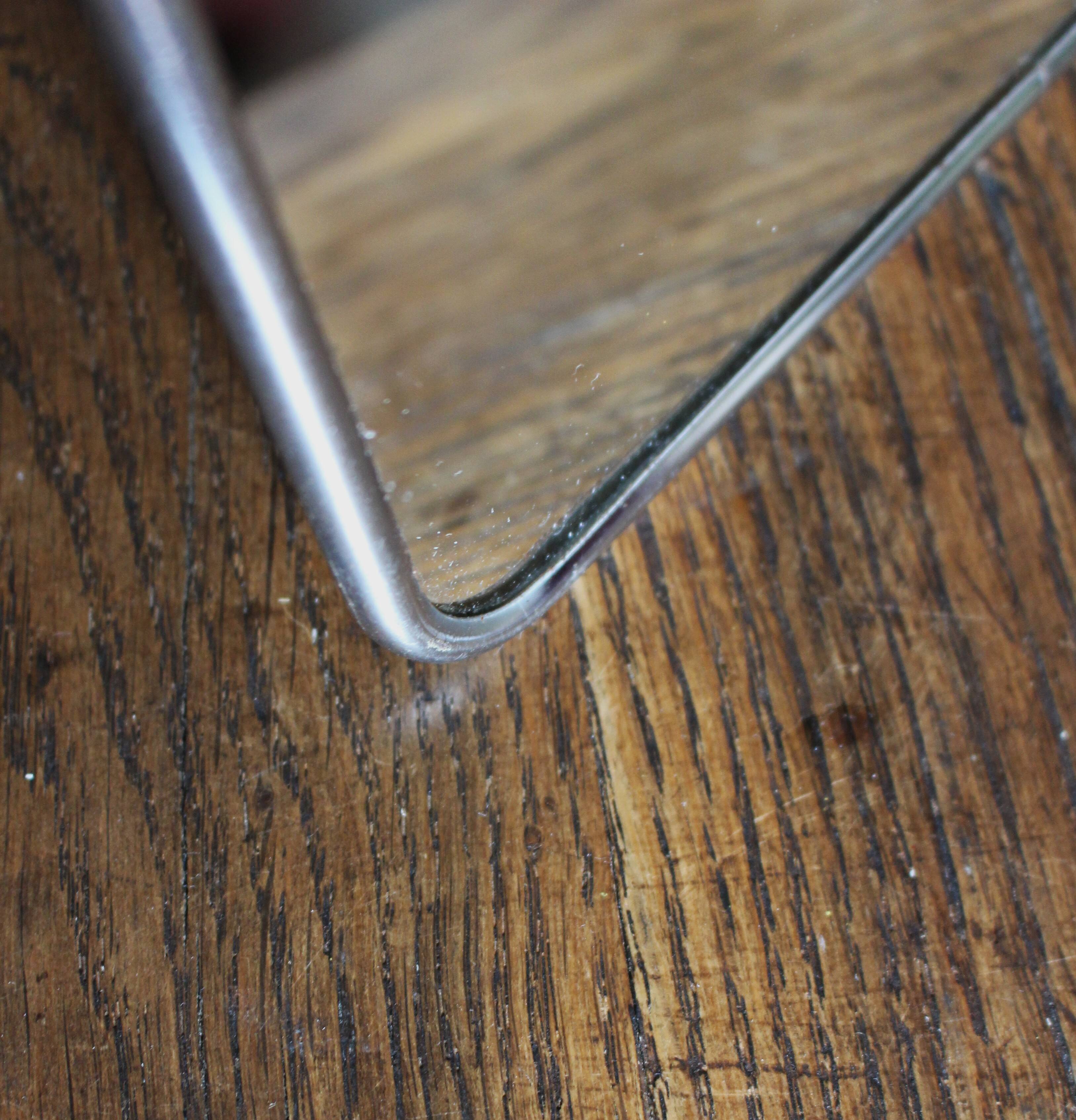 Simple rectangular barber mirror with a stand.