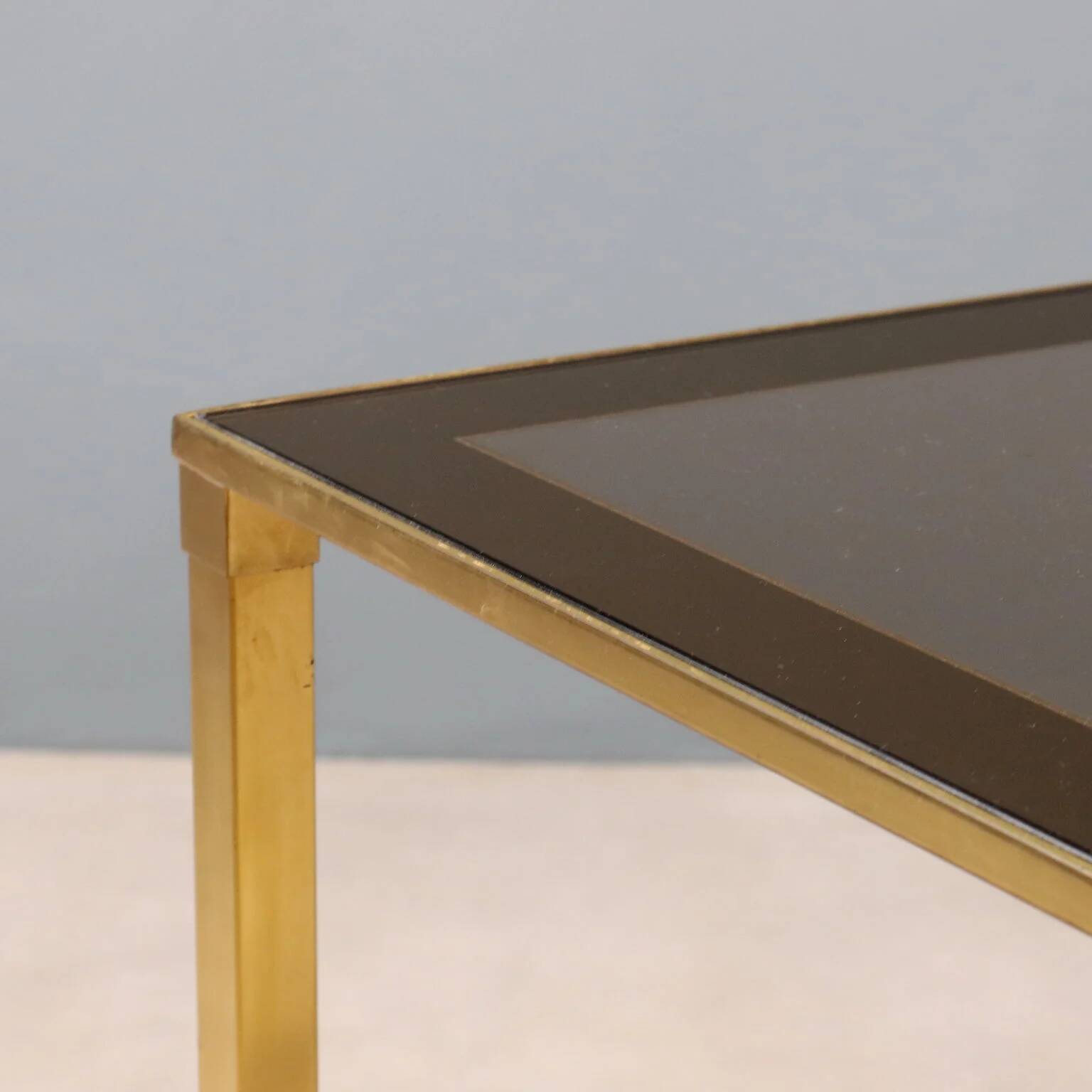 Nested tables in brass and smoked glass.