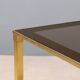 Nested tables in brass and smoked glass.