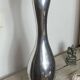 Large organic vase in polished aluminium cast.