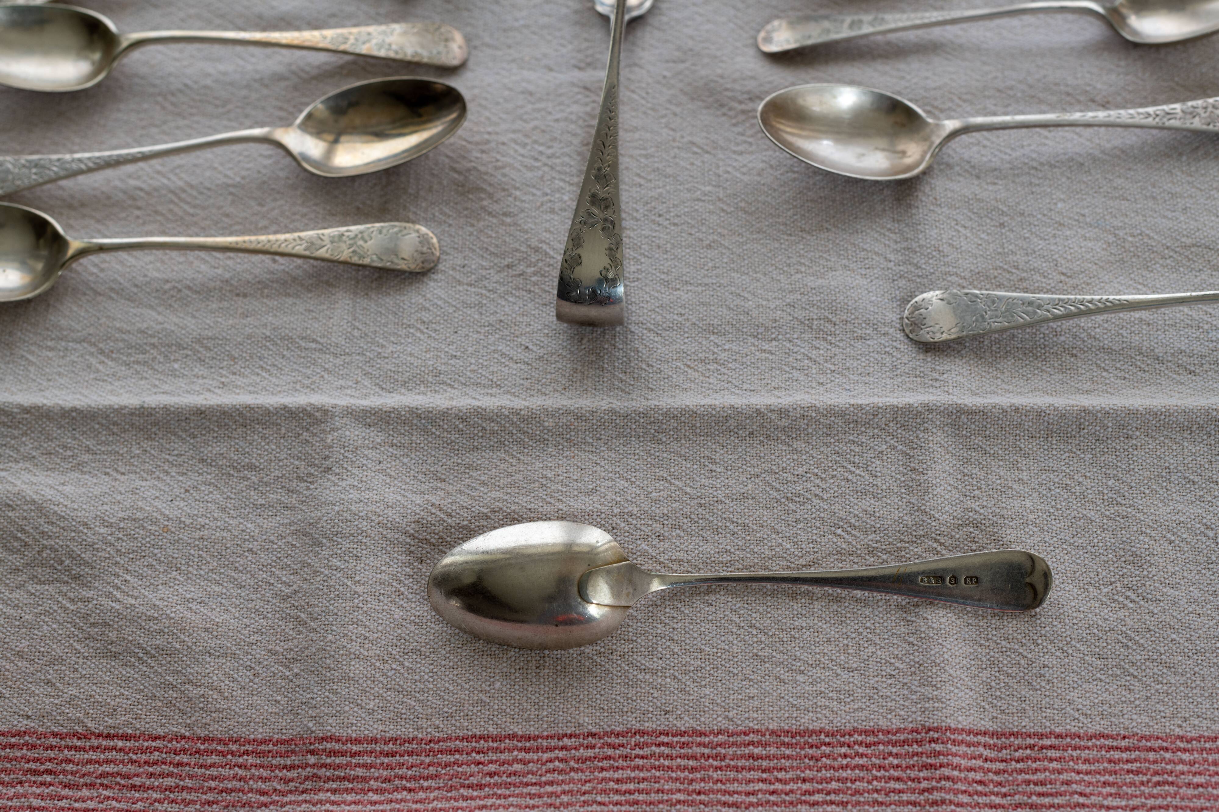 Box of old English coffee or tea spoons and their sugar tongs, silver plated