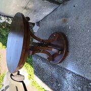 Art Deco side table in brown walnut, round top and scroll legs, France 1930s.