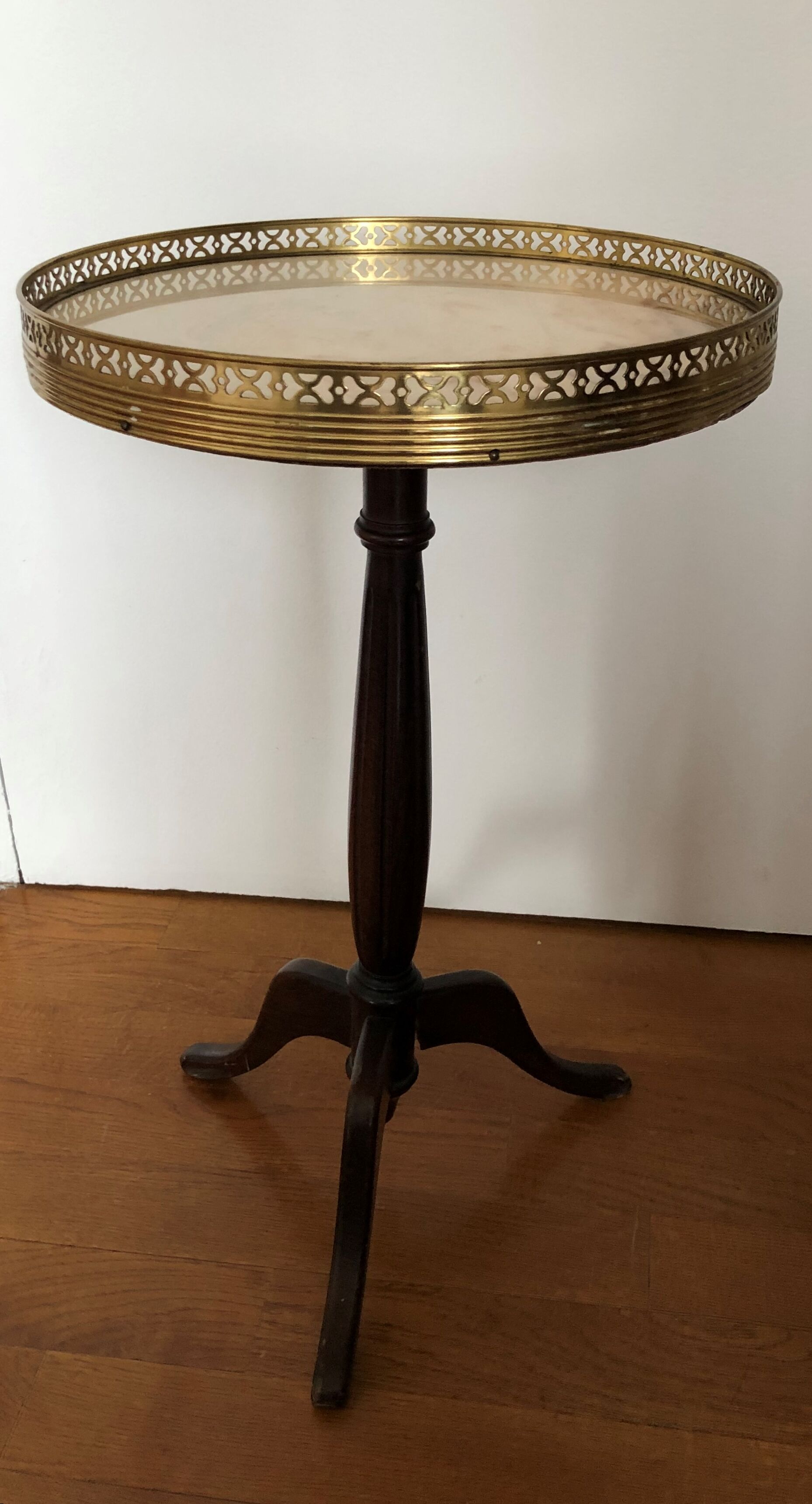 Wooden pedestal table on marble