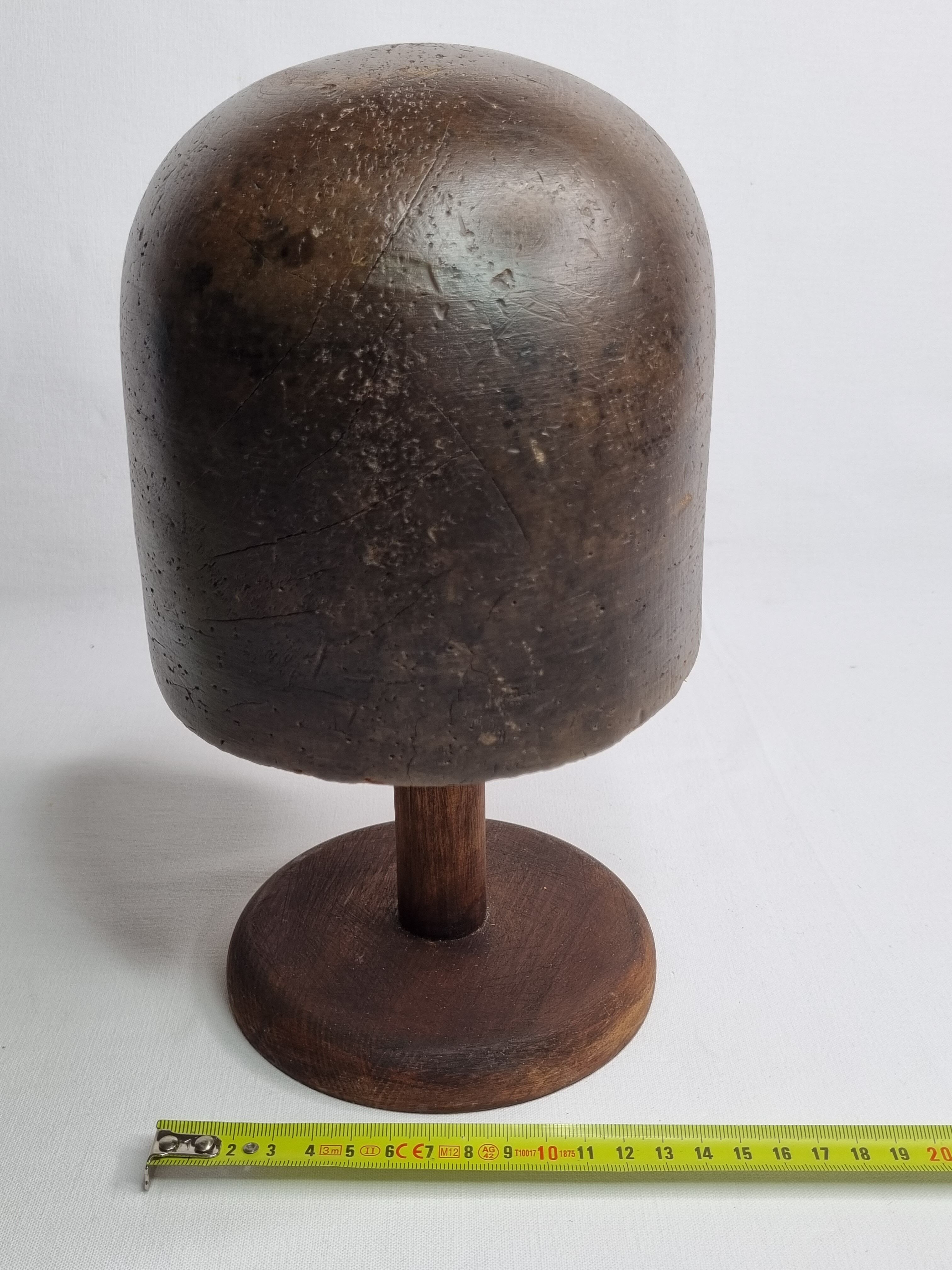 Old solid wood hat shape on foot, 1900